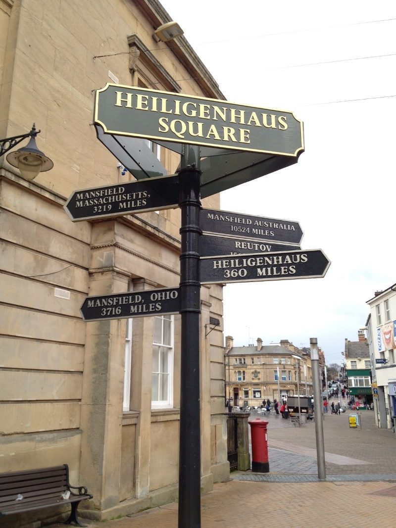 Finger post sign in Mansfield town centre pointing towards Mansfield's twin towns, including Mansfield, Massachusetts and Heiligenhaus